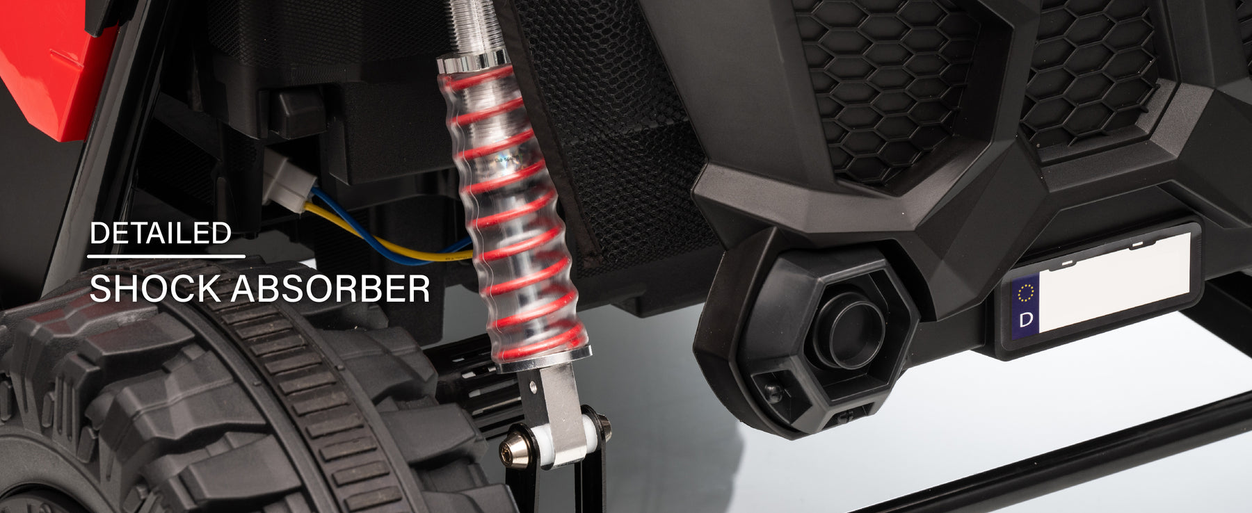 Rear shock absorber suspension on the 24V kids ride-on UTV